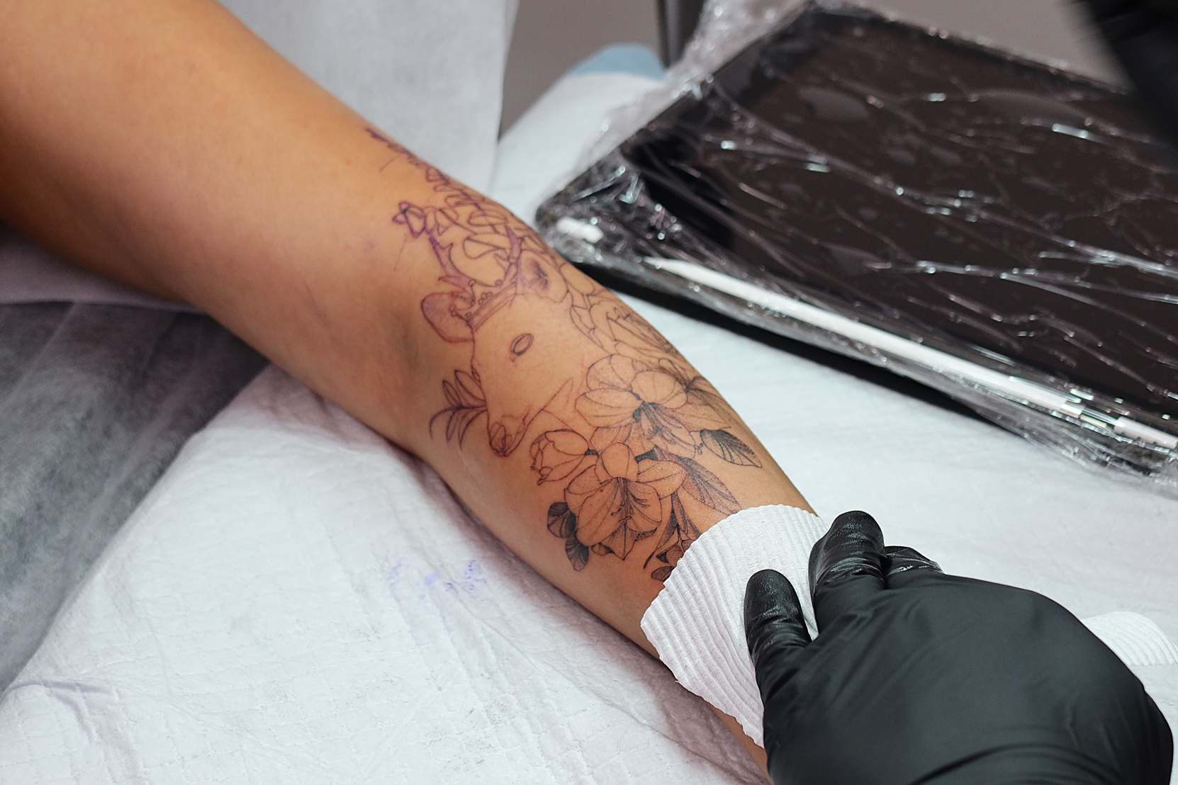 tattoo of a deer surrounded by flowers